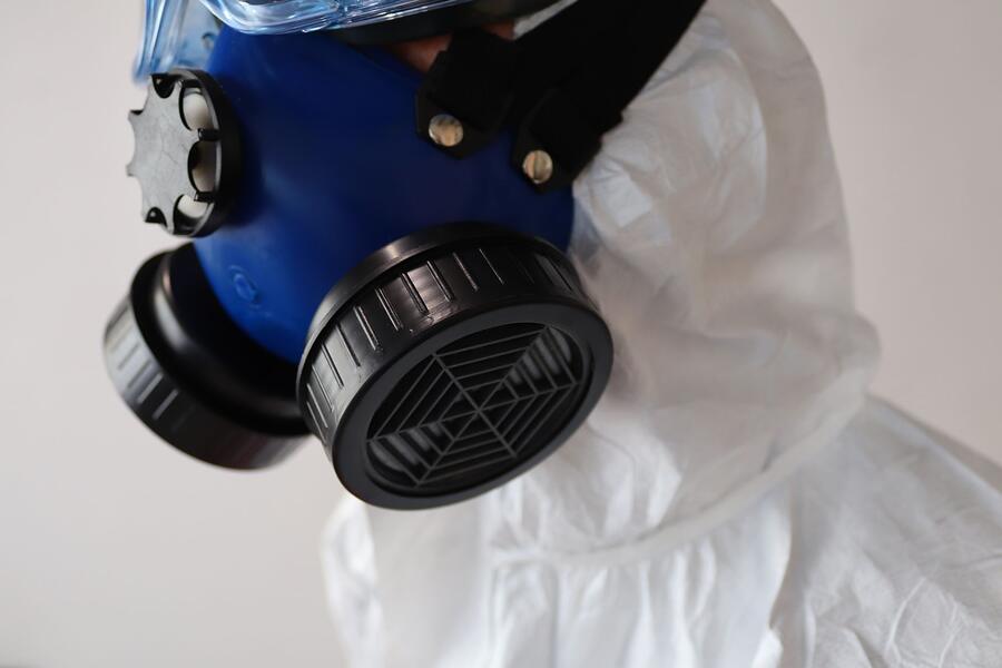 A protective respirator and white suit, close up