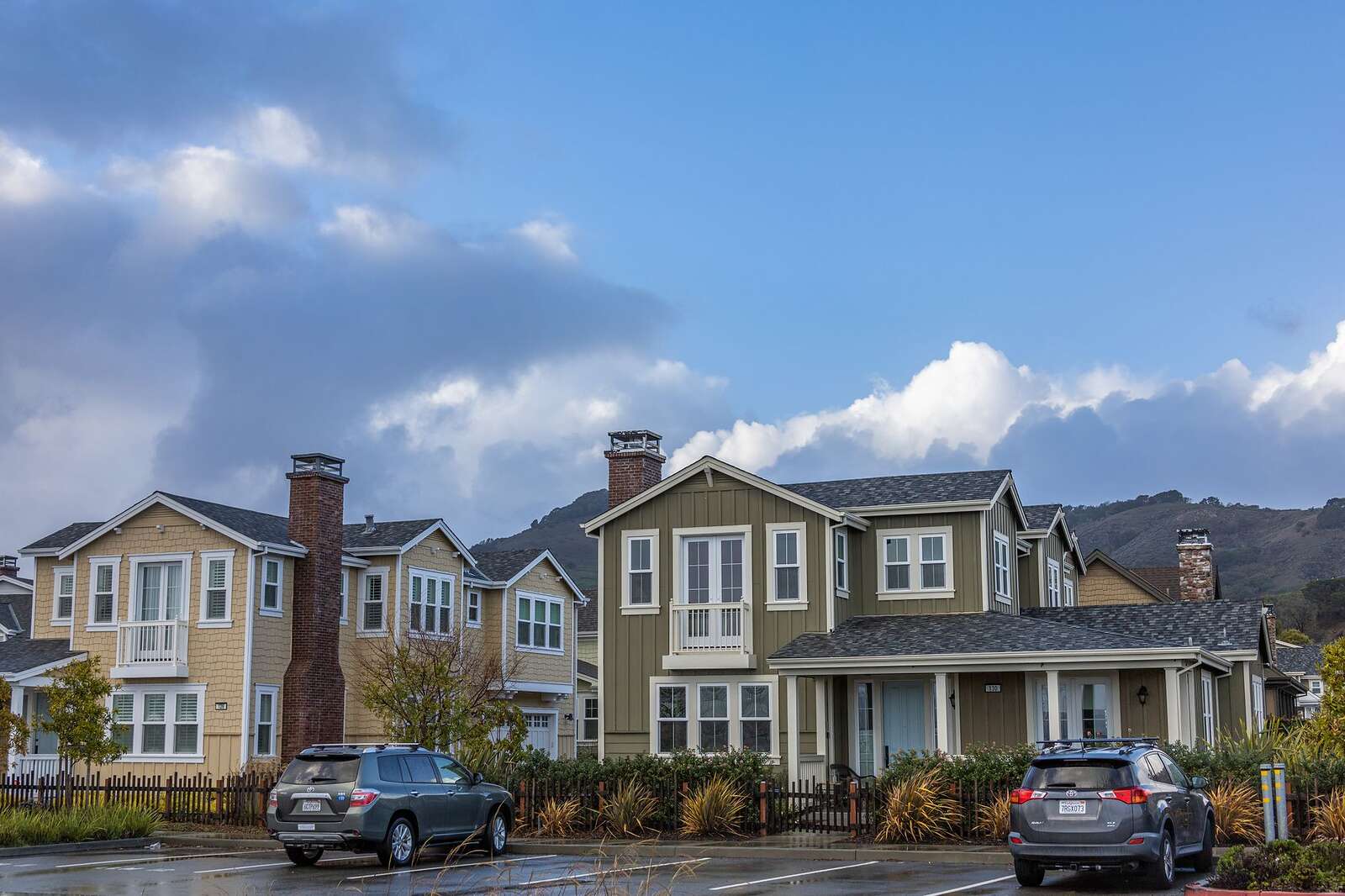 A suburban street of brick houses with attached garages